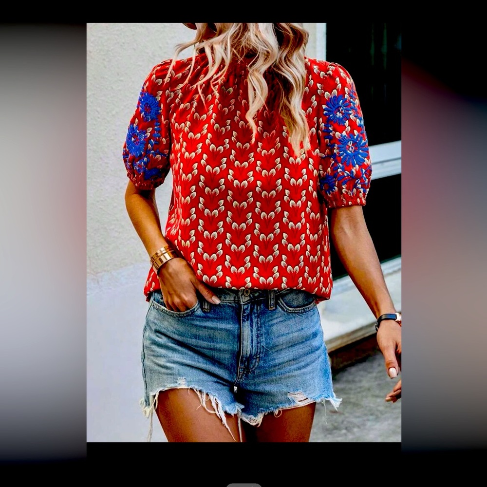 Red and blue puff sleeve top. Short sleeve. Blue embroidery.